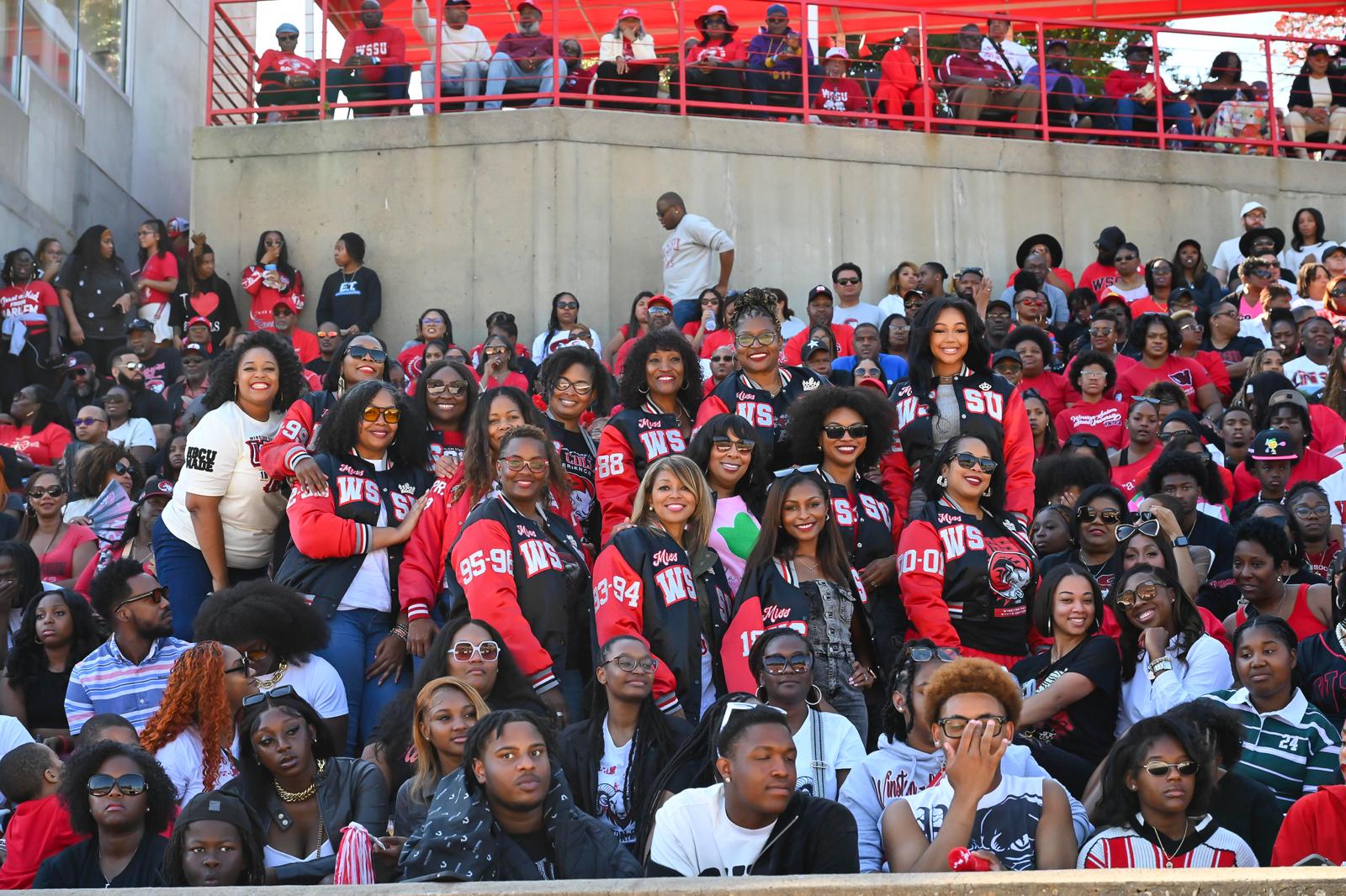 Wide shot of the collective filling the stadium bleachers
